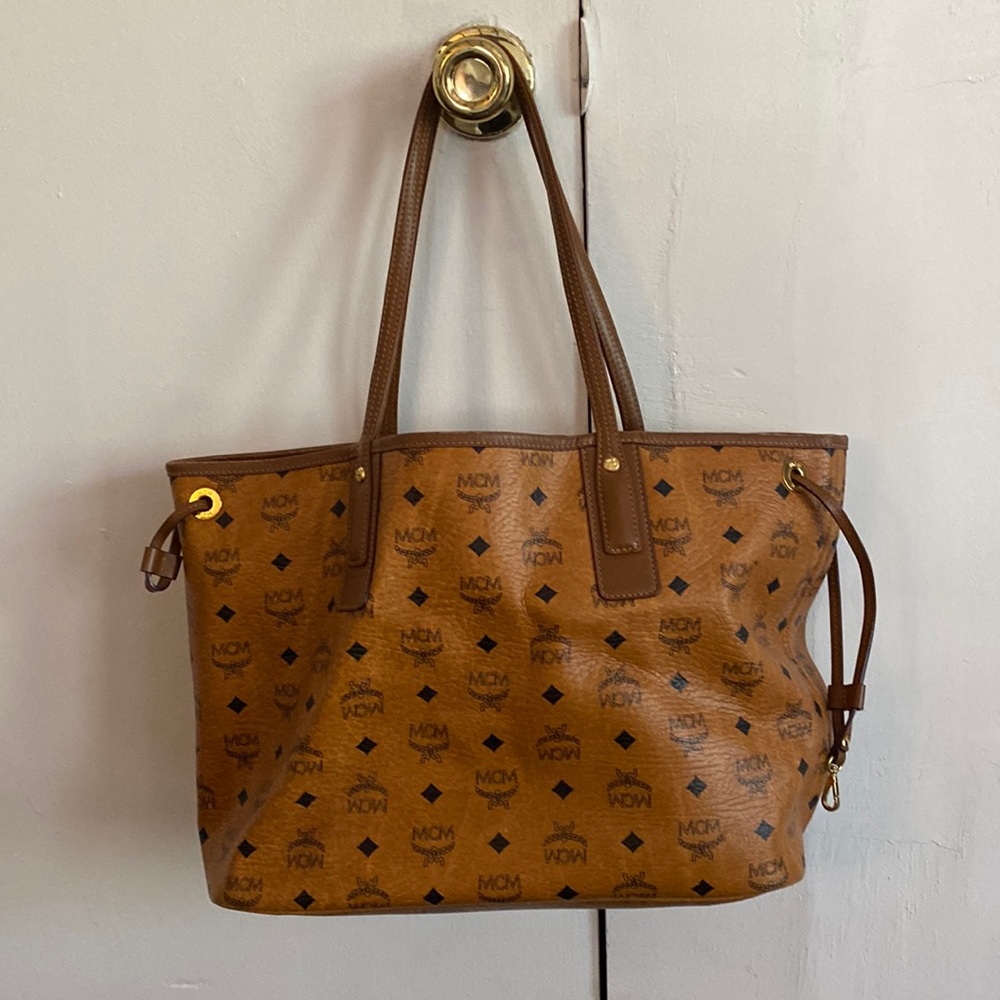 Like new. Beautiful MCM tote. Comes with large clutch.